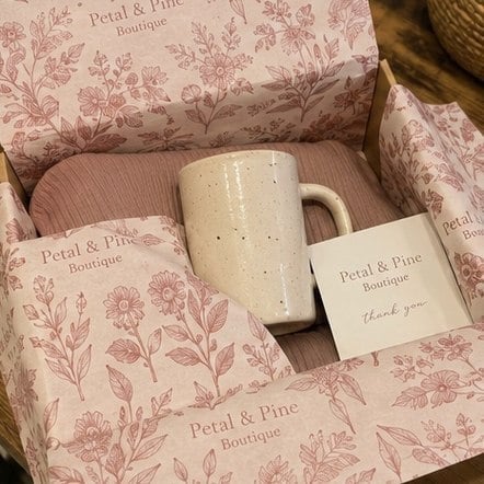 Full-coverage patterned custom tissue paper wrapping products in a gift box